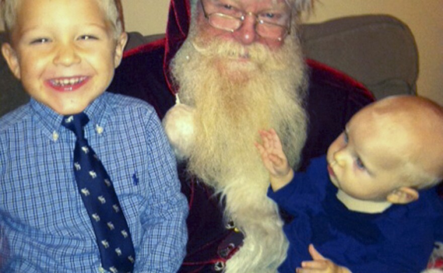 Applegate drops by a neighborhood Christmas party on Dec. 8. He says he fully commits to the character of Santa Claus, leaving Applegate at the door every time he suits up.