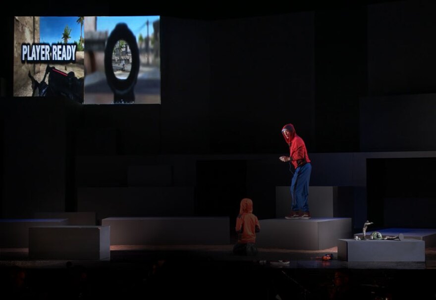 A scene from “Soldier Songs,” an opera by David T. Little. We follow the lead character through the phases of life from boy to man: playing war games and violent video games as a youth (pictured), enlisting and serving in the military, the real-life horrors of war and a father whose worst fears are realized with the news of the death of his son.