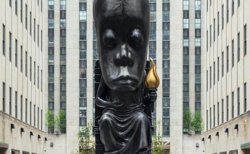 Sanford Biggers looks up at his <em>Oracle</em> sculpture when it was on display at the Rockefeller Center last spring.