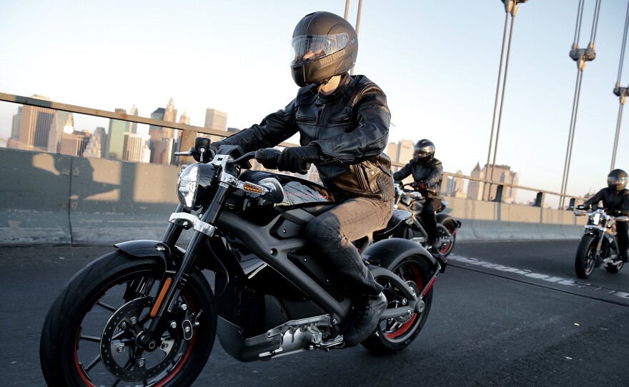 Harley-Davidson riders reveal Project LiveWire, the first electric Harley-Davidson motorcycle, during a ride across New York City's Manhattan Bridge on June 23.