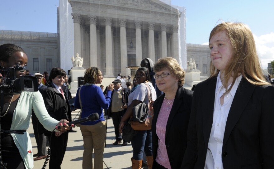 Abigail Fisher (right), the Texan involved in the University of Texas affirmative action case, walks outside the Supreme Court in 2012.