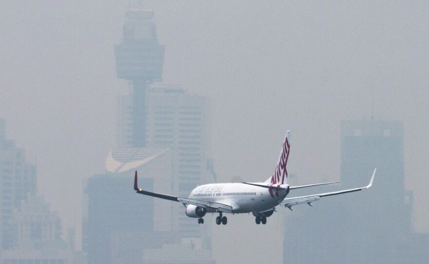 Australia is no longer processing new visa applications from the three worst-hit countries in Africa's Ebola outbreak. Here, a jetliner prepares to land at Sydney's International Airport.