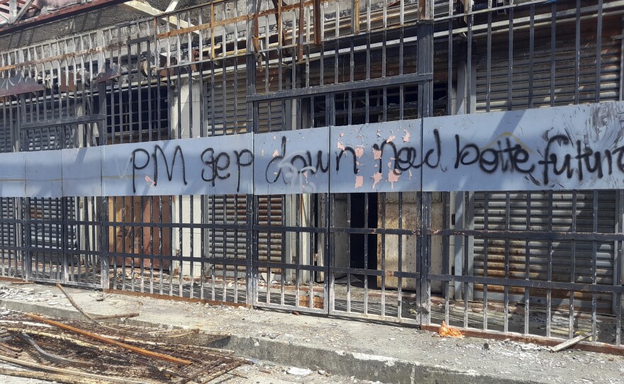 Graffiti written on the burnt out buildings from riots in Honiara's Chinatown from Nov. 2021, is seen in the Solomon Islands on March 30, 2022.