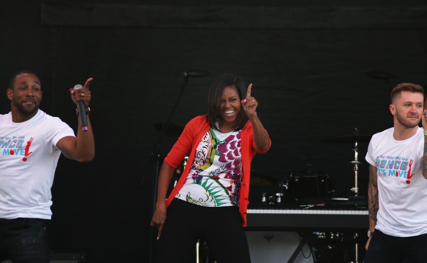 First Lady Michelle Obama wears her signature cardigan while dancing with performers from the television show So You Can Dance during the annual White House Easter Egg Roll on April 6, 2015.