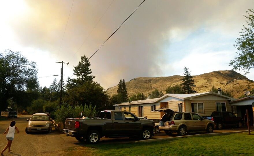 Smoke rises from a wildfire approaching Twisp, Wash., on Aug. 19. Smoke can damage the health of people hundreds of miles downwind.