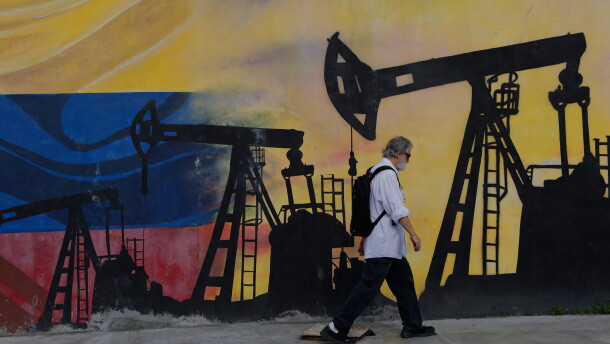 A pedestrian walks past a mural featuring oil wells in Caracas, Venezuela, Saturday, Aug 29, 2026, a day after President Donald Trump announced a deal giving the United States a stake in Venezuela's oil reserves.