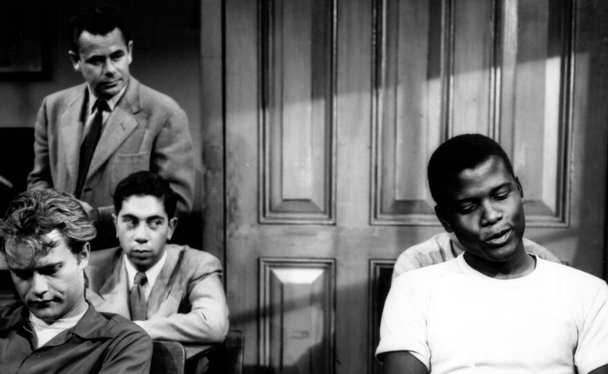 Sidney Poitier (right) and Glenn Ford (standing) in the 1955 film, Blackboard Jungle.