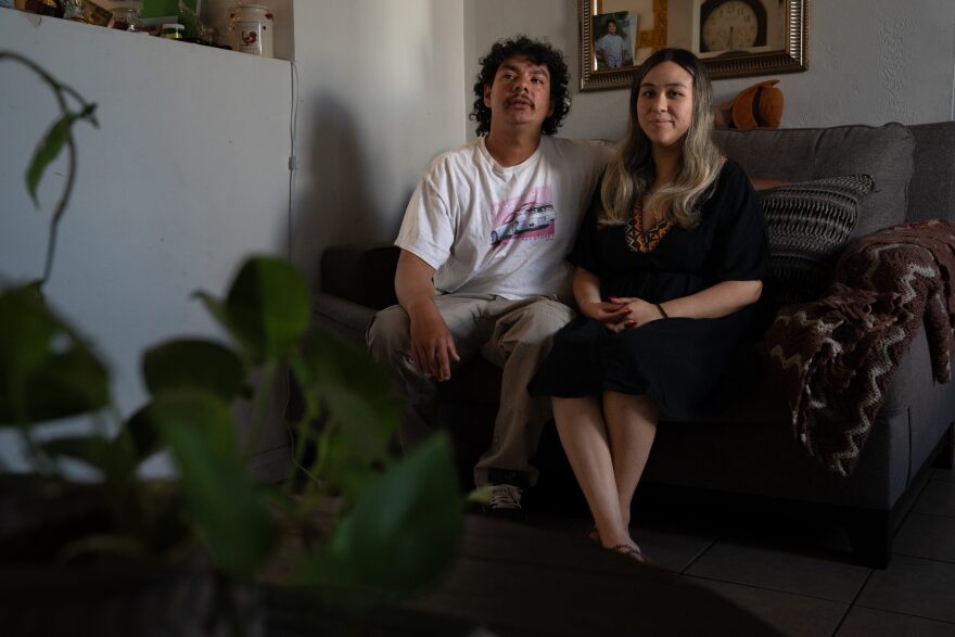 Barajas and her boyfriend Nicanor Verdugo sit on the living room couch in their family house in Holtville, Calif. on Aug. 22, 2024.