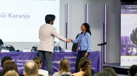 Wambūi Karanja of Kenya accepts the "One to Watch" award from the Alzheimer's Association for the guide she's developed to help family caregivers.
