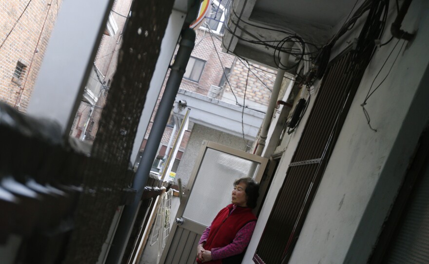 South Korea's Confucian tradition has weakened, and now elderly South Koreans increasingly live alone. In this photo from 2013, Kong Kyung-soon, a 73-year-old who lives alone, looks out of the door of her tiny rented apartment in Seoul.