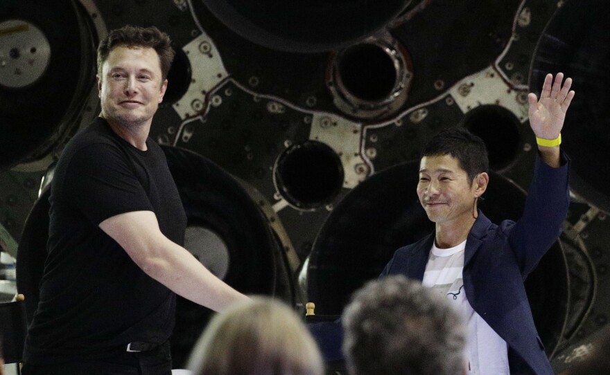 SpaceX founder and chief executive Elon Musk, left, shakes hands with Japanese billionaire Yusaku Maezawa, right, on Monday, after announcing that he will be the first private passenger on a trip around the moon.