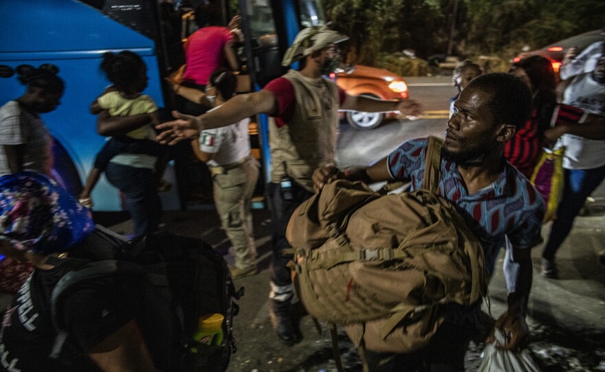 Haitian migrants boarding INM northbound buses in Tapachula.