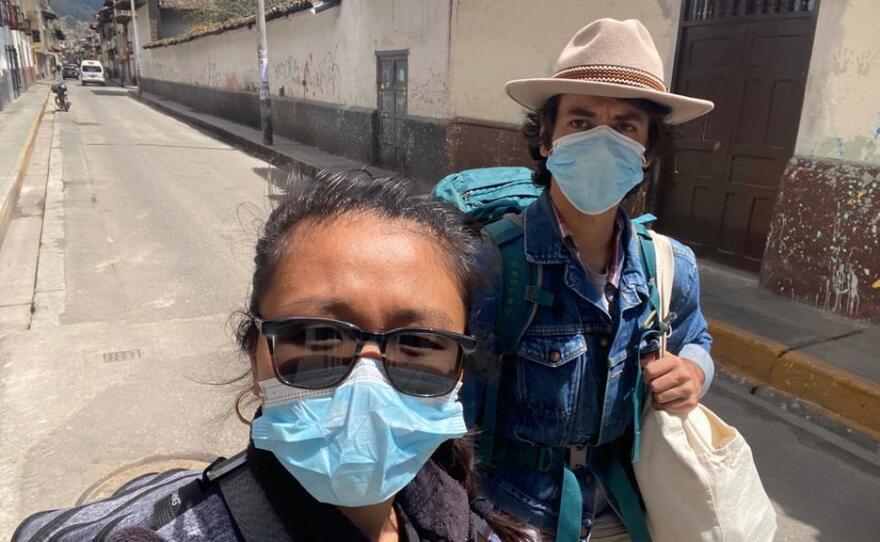 Pu Ying Huang (left) and Dylan Baddour walk along an empty street in Cajamarca, Peru, on March 18, while they were moving from a small hotel room to an Airbnb to ride out the country's 15-day lockdown.