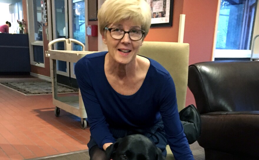 Karen Lorne, diagnosed with Lou Gehrig's disease in July, volunteers weekly with her certified therapy dog, Bailey, at the Ronald McDonald House in Chapel Hill, N.C.