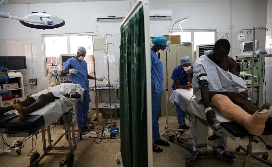 The operating theater at the Edward Francis Small Teaching Hospital is split in half so two surgeries can happen simultaneously. This allows Marenah to oversee two operations at the same time and helps reduce the backlog of patients waiting for surgery.