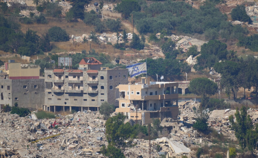 An Israeli flag tops a destroyed building in southern Lebanon, as seen from northern Israel, Sunday, June 28, 2026.