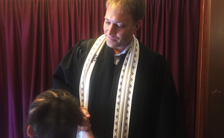 The Rev. Seth Kaper-Dale shakes hands after a service at the Reformed Church of Highland Park.