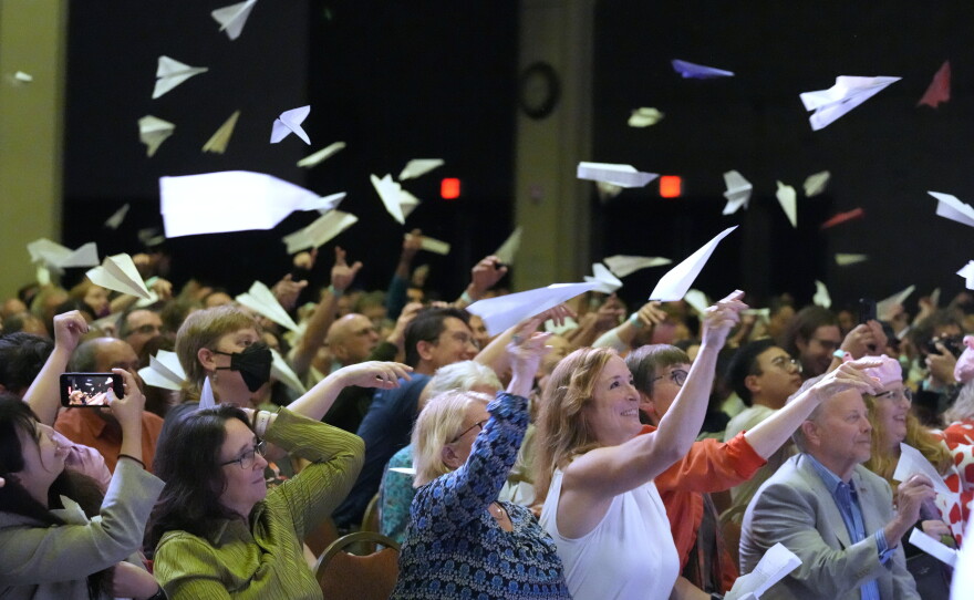 Audience members toss paper airplanes during the 2025 Ig Nobel Prize award ceremony in Boston, Mass.