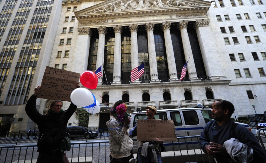 <p>Occupy Wall Street participants demonstrate in front of the New York Stock Exchange in September. The group's press team says the point of the protests is to address the public and not CEOs, whose headquarters have left Wall Street.</p>
