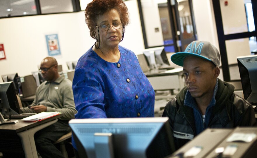 Part-time librarian Janet Sims-Wood, 67, helps student Andre Williams navigate the online catalogue at the Accokeek Library at Prince George's Community College in Largo, Md.