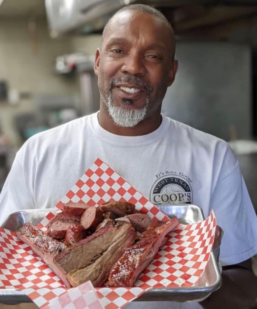 Bradrick Cooper showing off some of his "legendary" BBQ at Coop's West Texas BBQ in Lemon Grove. Undated photo.