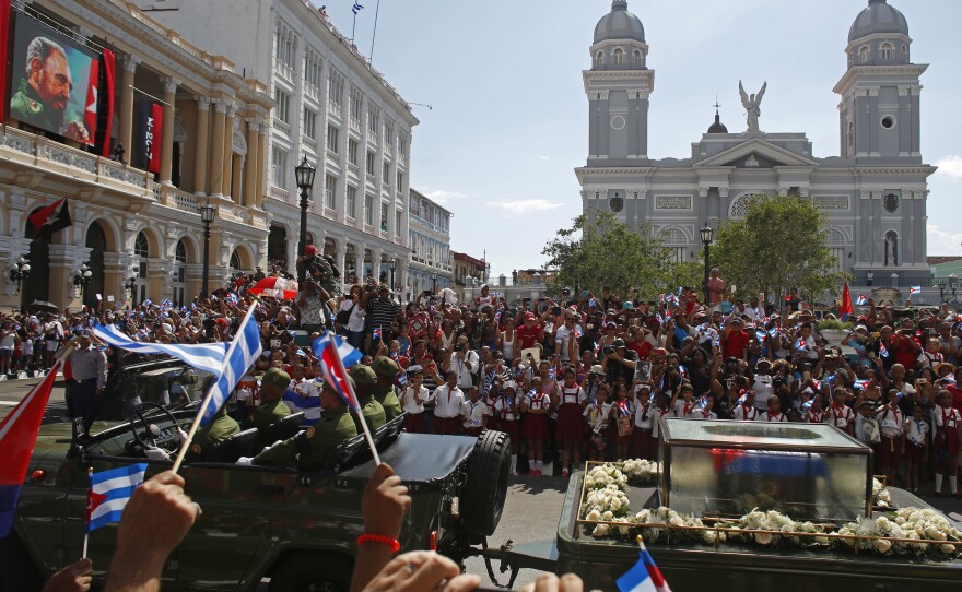 People chant "I am Fidel!" as the motorcade carrying the ashes of the late Cuban leader Fidel Castro leaves Cespedes park in Santiago, Cuba.