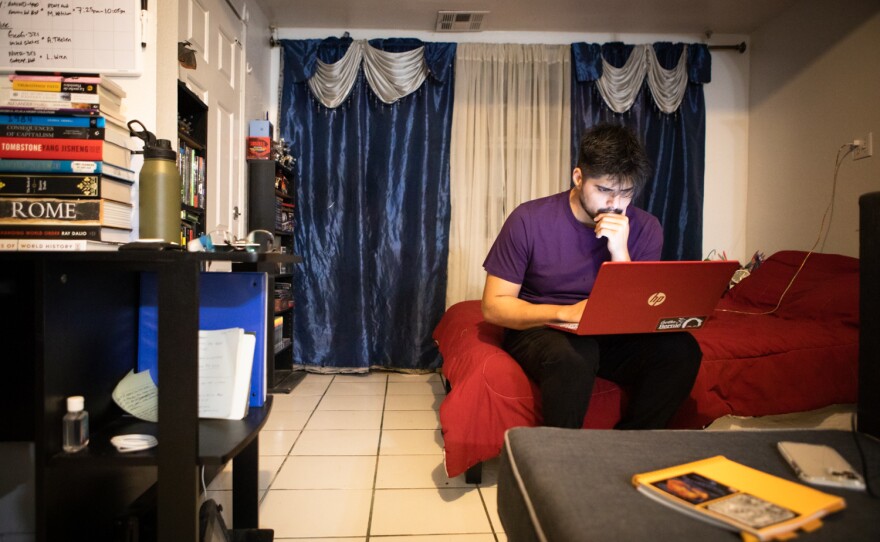 Gilberto Manzanarez looks at his schedule before a day of campaigning in Calexico, Oct. 8, 2022. 