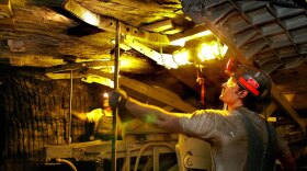 Coal miners work in a mine near Coulterville, Ill., in 2006.