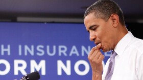 U.S. President Barack Obama pauses during a town hall meeting on healthcare at the headquarters of the Democratic National Committee August 20, 2009 in Washington, DC. Obama answered questions from people on his plan for healthcare reform during the town hall.