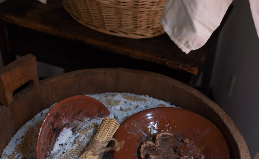 A replica of dirty dishes being washed is seen in the quarters and kitchen used by enslaved people to prepare food at the Paca House.