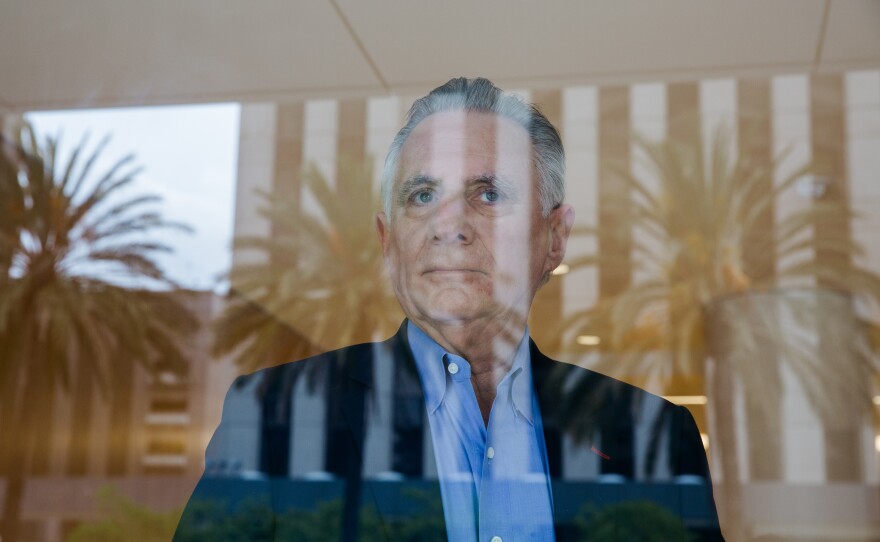 Co-founder Martin Pichinson stands behind a window at Sherwood Partners, which helps shut down startups in financial trouble.