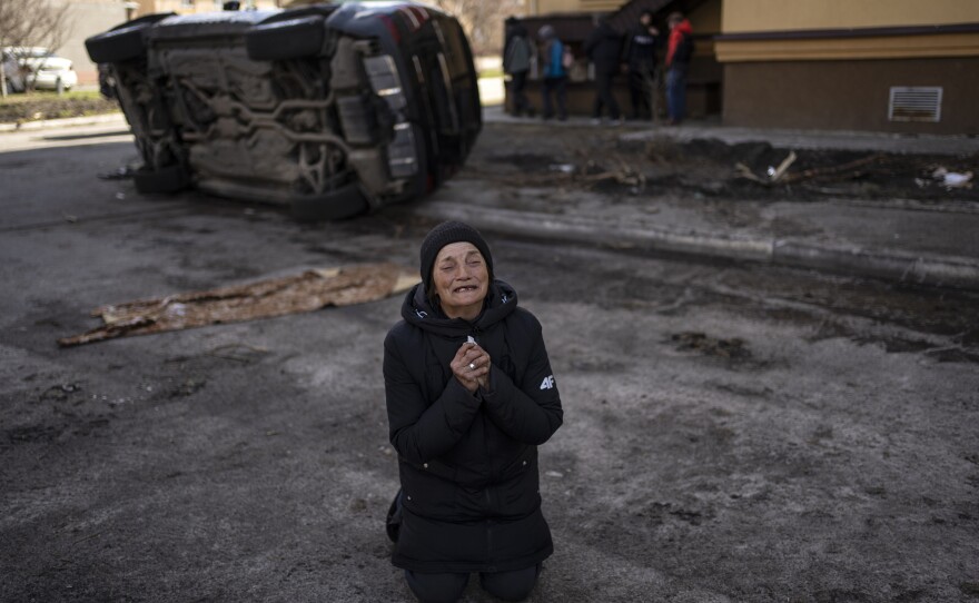 A woman mourns the death of her husband, killed in Bucha.