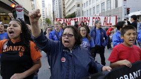 Guadalupe Chavez, center, and others yell during a protest outside of the U.S. Citizen and Immigration Services building in San Francisco, Monday, May 1, 2017. I