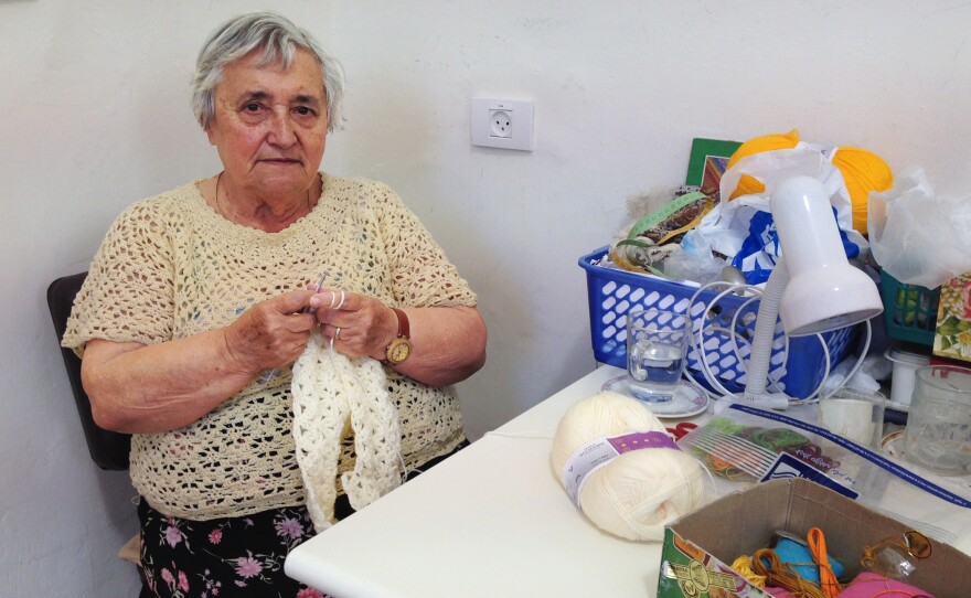 Yulia Feuerman receives about $400 a month from a German government fund. She currently doesn't receive any financial assistance from Israel due to a law that stipulates that money Germany gave to Israel more than half a century ago can only be offered directly to survivors who arrived by 1953. Feuerman arrived in Israel a decade later. Here, she knits at the Lifeline crafts workshop in Jerusalem.