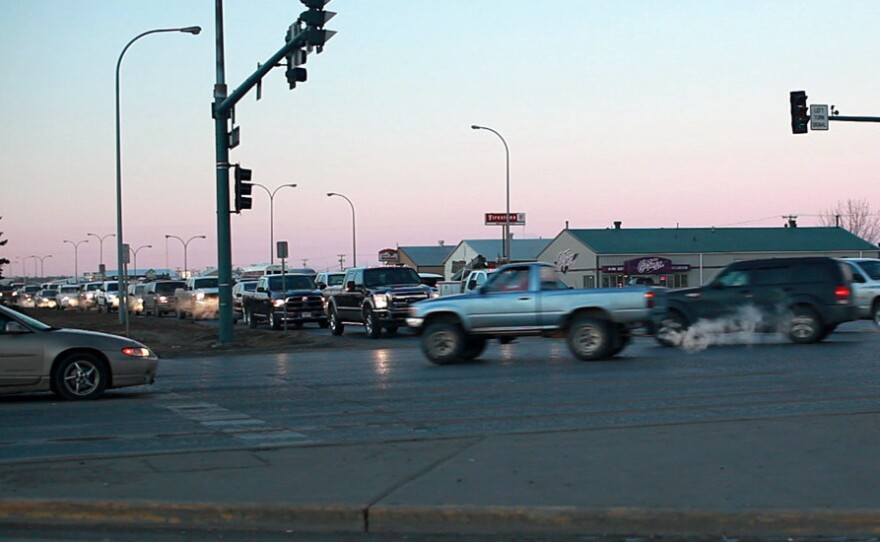 Trucks crowd a busy intersection during rush hour in Williston, N.D.