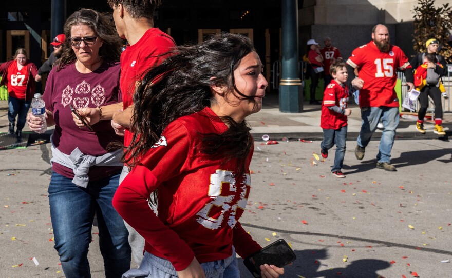 People flee after shots were fired near the Kansas City Chiefs' Super Bowl victory parade on Wednesday in Kansas City, Mo.