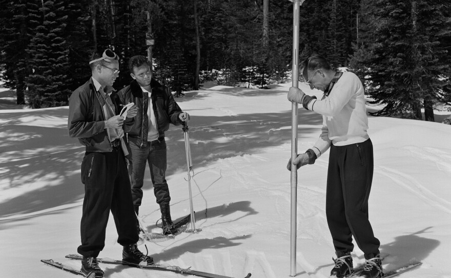 Left to right, Jack Hannaford, helicopter pilot Harry Rodgers and Robert Miller, Chief of the Snow Survey Office for the California Department of Water Resources conducts the monthly snow survey near Loon Lake reservoir in the Eldorado National Forest in El Dorado County, Calif. The team used a helicopter to get to the remote location in the Sierra Nevada Mountains. Photo taken March 9, 1960.