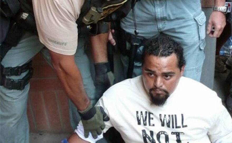 Carlos Garcia arrested as he protests the implementation of SB 1070.