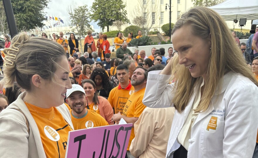 Hannah Miles of Birmingham speaks with Dr Dr. Mamie McLean outside the Alabama Statehouse in Montgomery, Ala. on Feb. 28, 2024. They were among patients and doctors urging Alabama lawmakers to take action to get IVF services in the state. Fertility clinics paused some services in the wake of a state court ruling related to whether embryos are children under a state law.