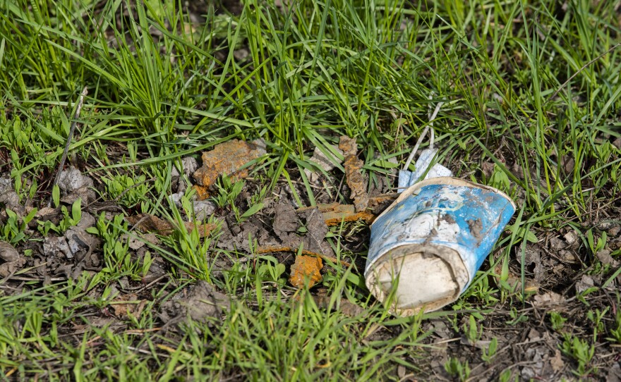Shrapnel from an airstrike in Bilashi sits rusted on the side of the road next to a resident's house. A resident of Bilashi said the shrapnel struck his house. He also said the town has been consistently hit by various munitions since March.