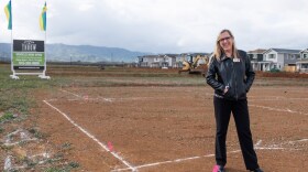 Laura Pope, sales consultant for Homes By Towne stands where homes will be built in Winters, Calif., Monday, March 8 2021.

