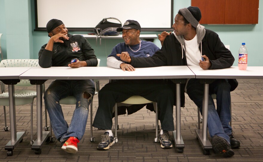 From left, Stephen Johnson, Harrelle Felipa and Cornelius Dixon attend a Responsible Fatherhood meeting at the Center for Urban Families on Nov. 11 in Baltimore. In exchange for participation in programs such as this, the state will reduce the men's child support debt.
