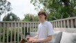 Liam Winstead, a staff reporter at the wildfire tracking service Watch Duty, sits for a portrait at his home in San Diego, California on August 27, 2025. When local fires break out, Winstead works on his balcony to monitor radio traffic.