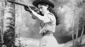 Born Phoebe Anne Moses in Greenville, Ohio, Annie Oakley (pictured with her gun) pulled herself out of the depths of poverty to become an iconic performer and a symbol of the Wild West. This program presents the story of the five-foot sharpshooter who never missed a shot.