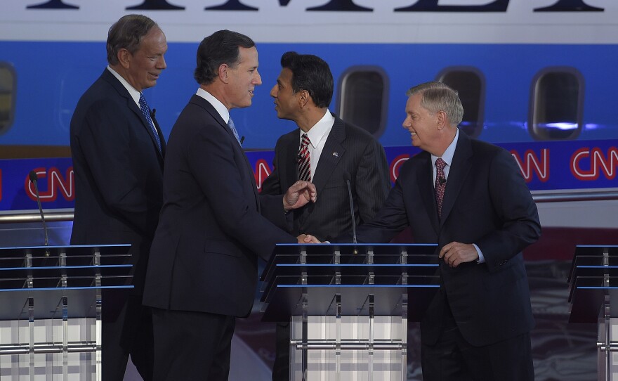Republican presidential candidates, former New York Gov. George Pataki, left, former Pennsylvania Sen. Rick Santorum, second from left, Louisiana Gov. Bobby Jindal, second from right, and Sen. Lindsey Graham, R-S.C., talk together at the finish of their CNN Republican presidential debate at the Ronald Reagan Presidential Library and Museum last month.