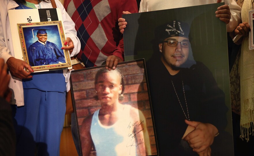 Community leaders and family members of murder victims attend a press conference Jan. 3 at St. Sabina Church in Chicago to make a plea for stronger gun regulations.