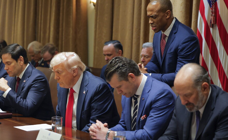 Housing and Urban Development Secretary Scott Turner prays during a Cabinet meeting with President Donald Trump at the White House in Washington on Feb. 26, 2025, as Secretary of State Marco Rubio and Defense Secretary Pete Hegseth also bows his head.