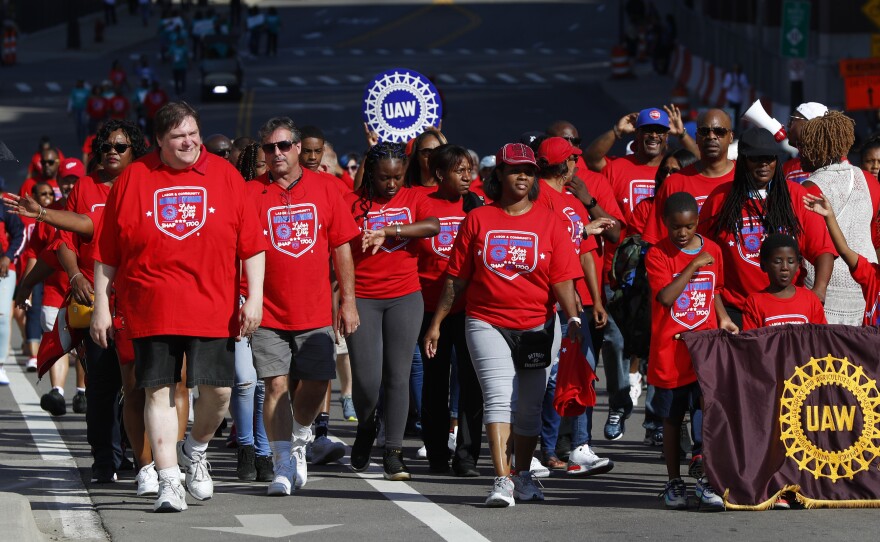 United Auto Workers members walk in the Labor Day parade' in Detroit, Monday, Sept. 2, 2019.