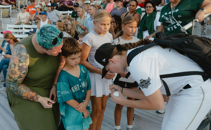 One of the LA Queens' players signs autographs for fans in the crowd during the game between the San Francisco Firebells and the Boston Hunters on Sunday, Aug. 2.