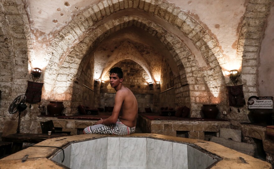 A Palestinian man relaxes at the ancient Samaritan Hammam, a traditional Turkish steam bath, in Gaza City, on March 3, 2021.